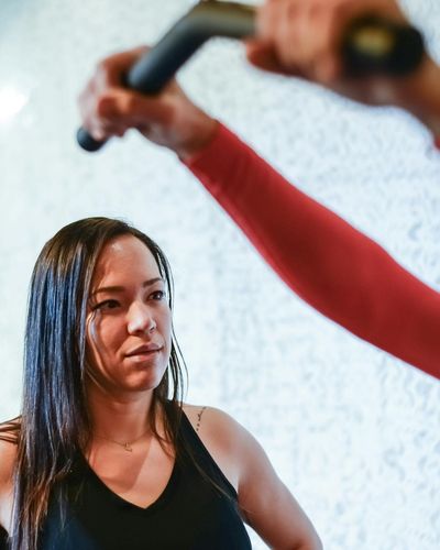 Professional female coach looking confident in a gym environment.